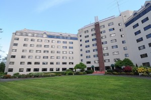 a very large residential building with a green lawn