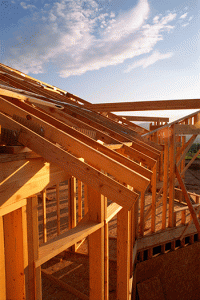 View of the roof of a house under construction with blue sky in the background.