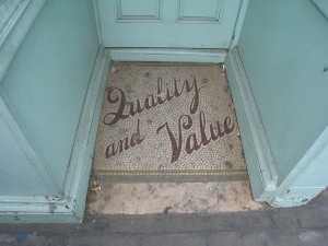 tile inlay in a door entry reading quality and value