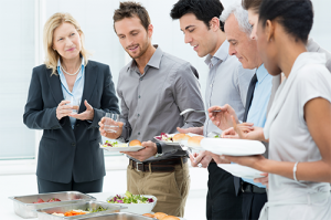 a group of people enjoying the buffet at a training seminar